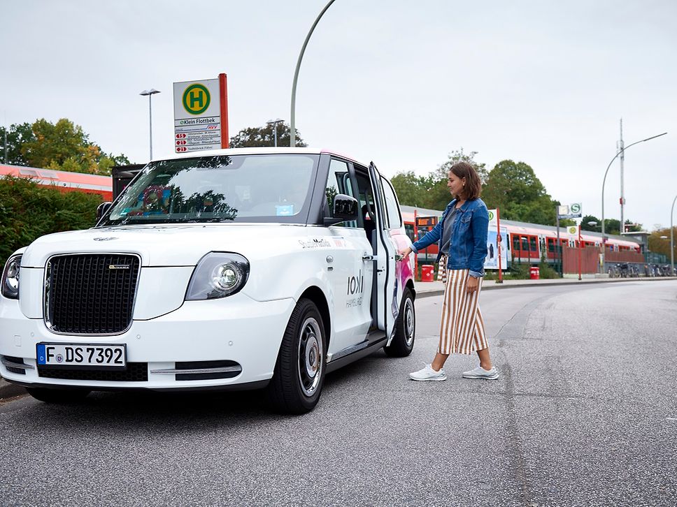 a woman gets into a car