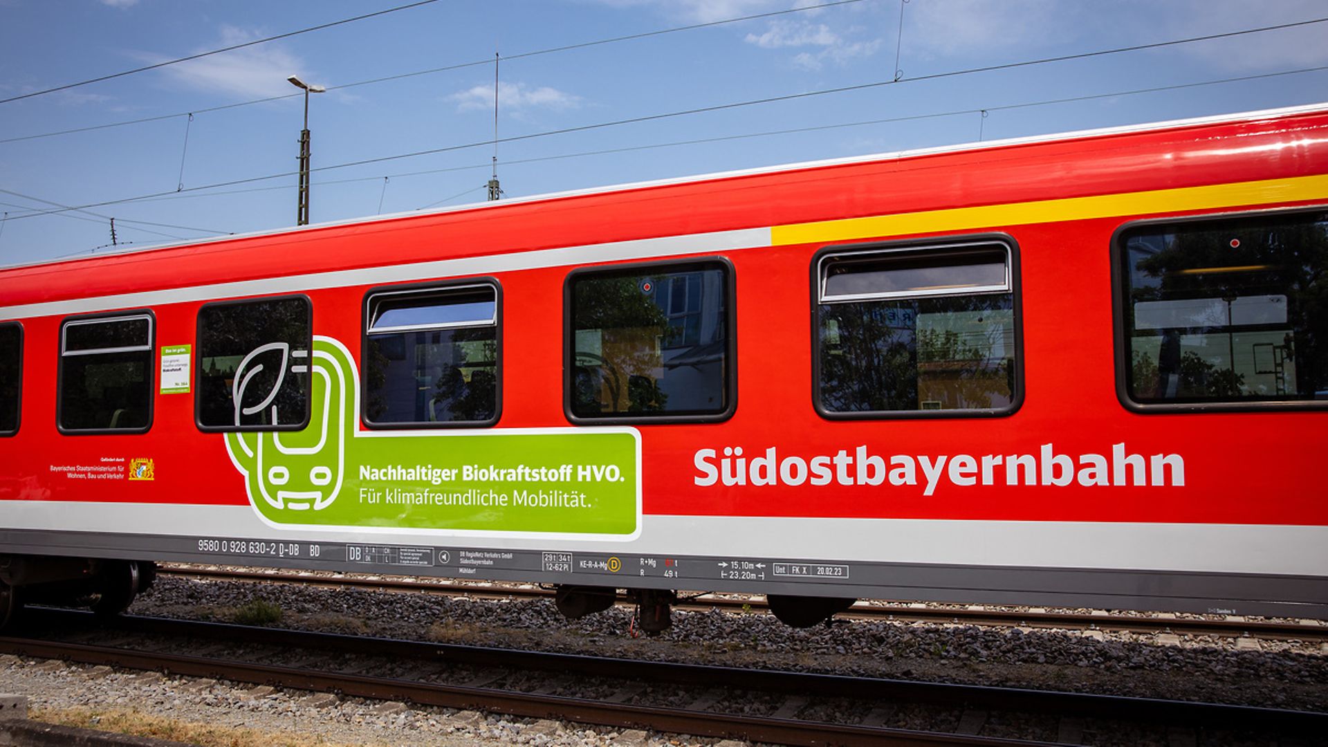 A red DB train with Deutsche Bahn's environmental label