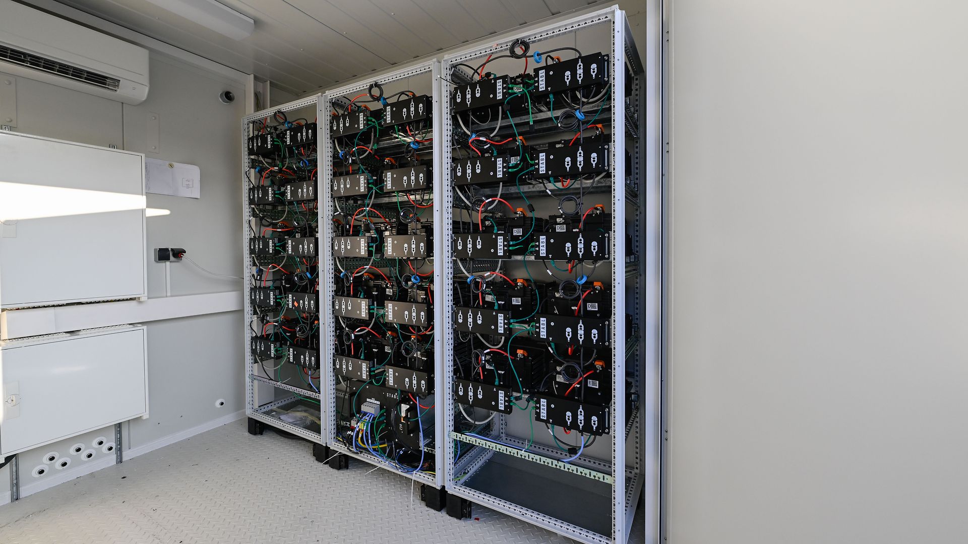 A room with several shelves in which batteries are stacked.